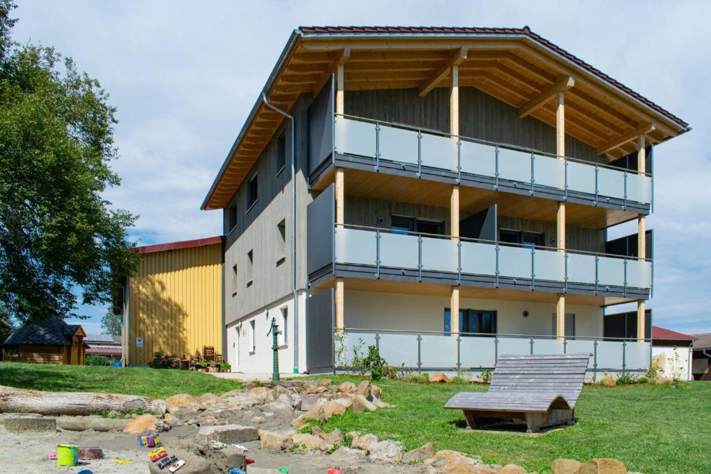 a building with a bench in front of it at Ferienwohnungen Bosserthof in Donaueschingen