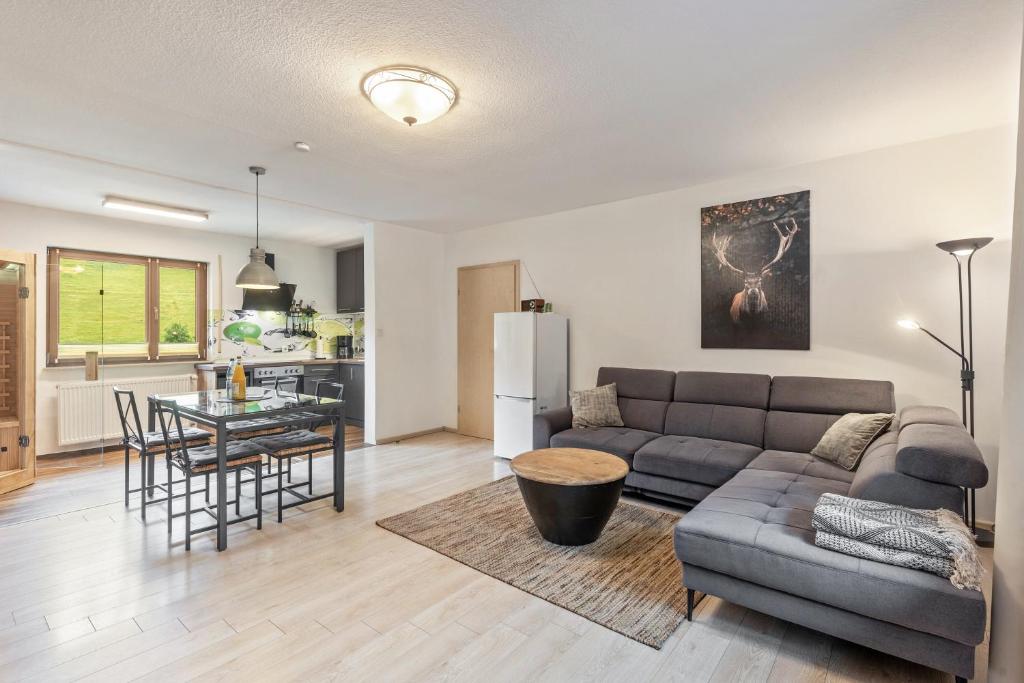 a living room with a couch and a table at Hof Helmenhube 2 in Oberzent