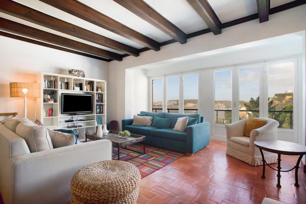a living room with two couches and a tv at São Martinho All The Best in São Martinho do Porto