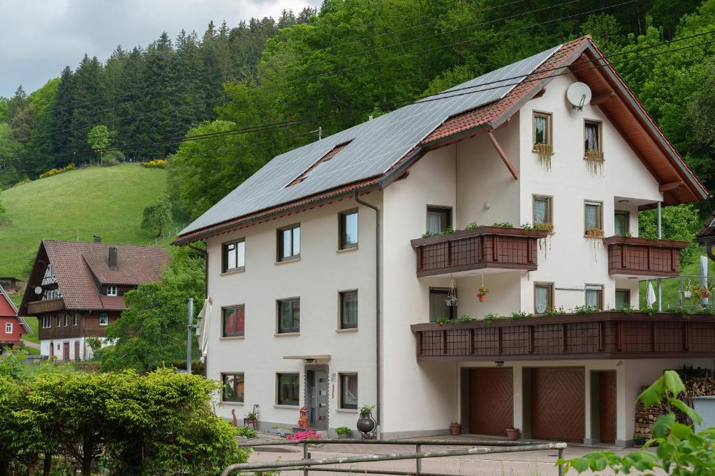 a white house with a metal roof at Gästehaus Gerda in Bad Peterstal-Griesbach