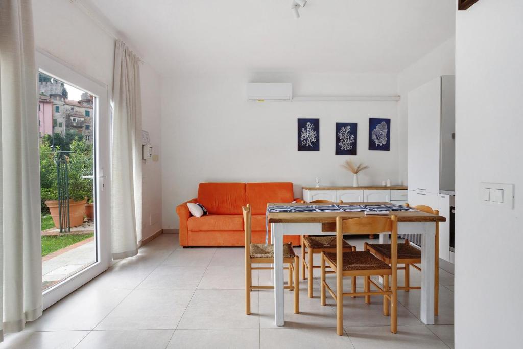a living room with a table and chairs and a couch at Montemare in Ameglia