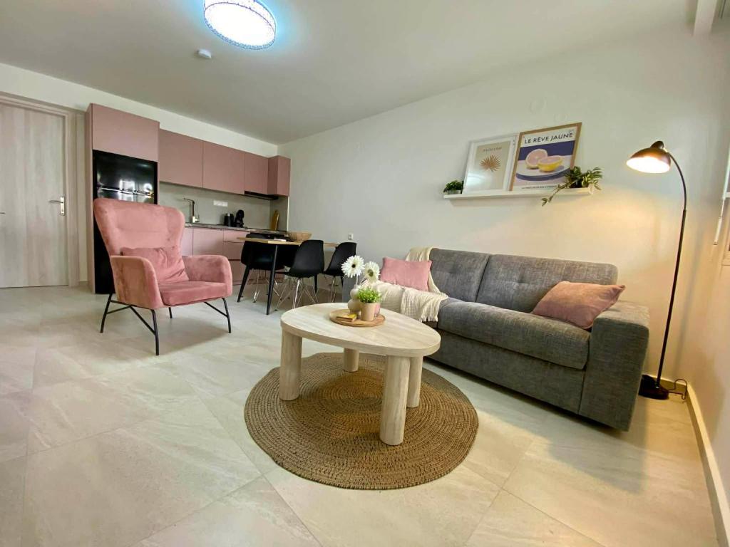 a living room with a couch and a table at Nikol's central suite 1 in Nea Peramos