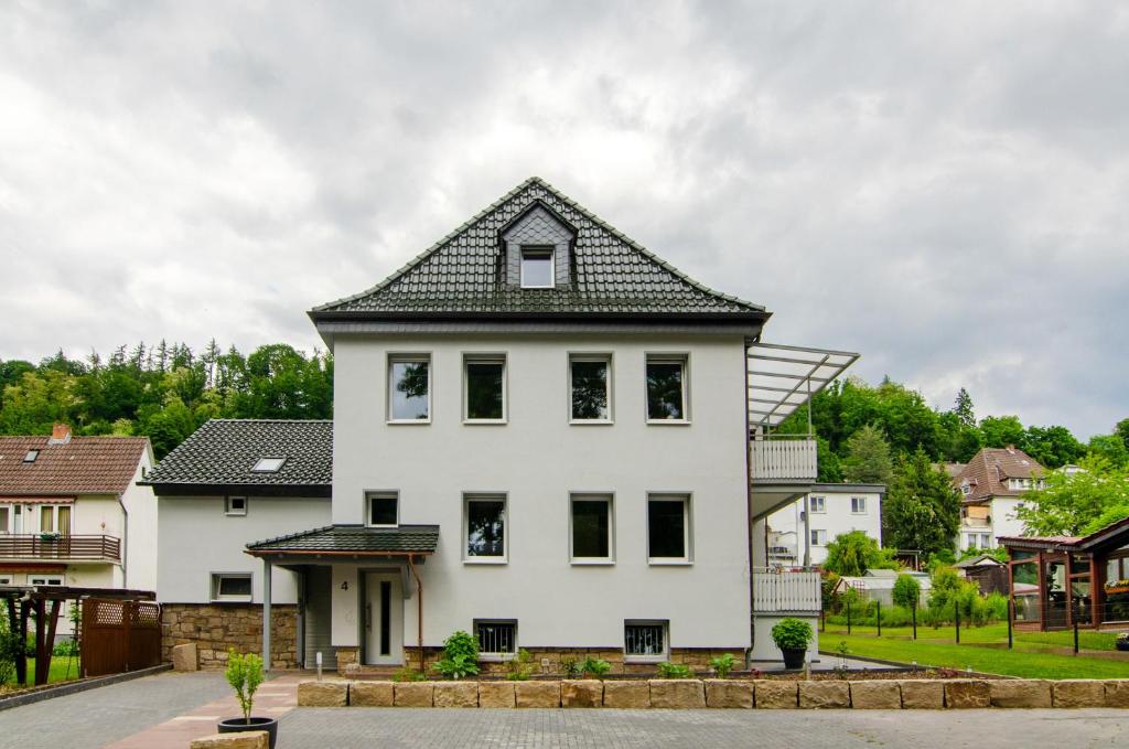 a white house with a black roof at Ferienhaus Berger 2025 in Bad Karlshafen