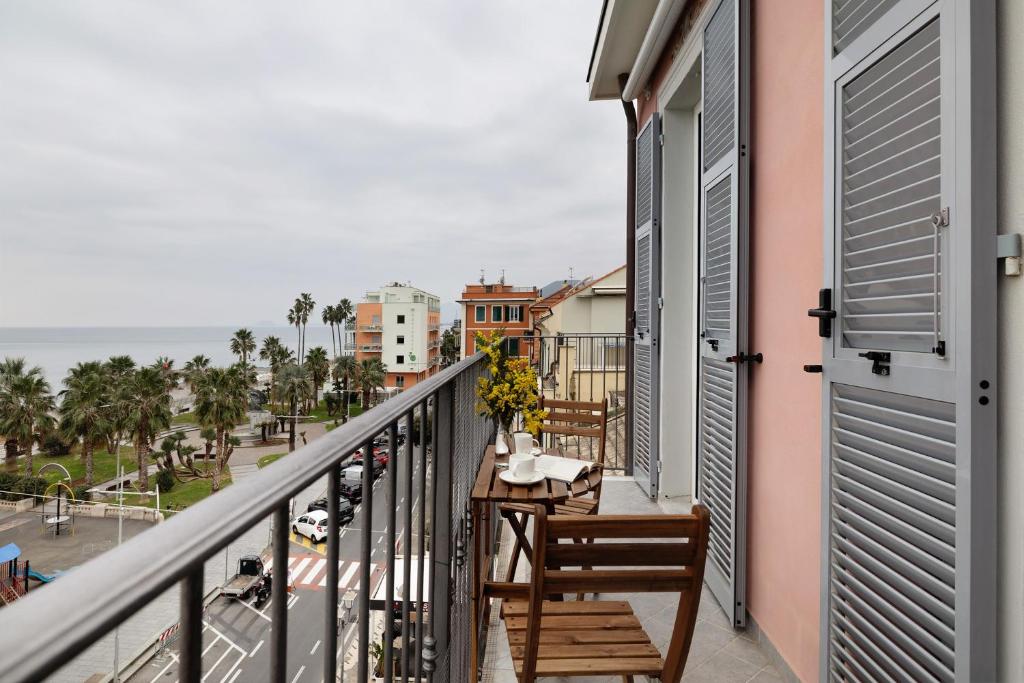 a balcony with a table and chairs and a view of the ocean at Puntodivista in Loano