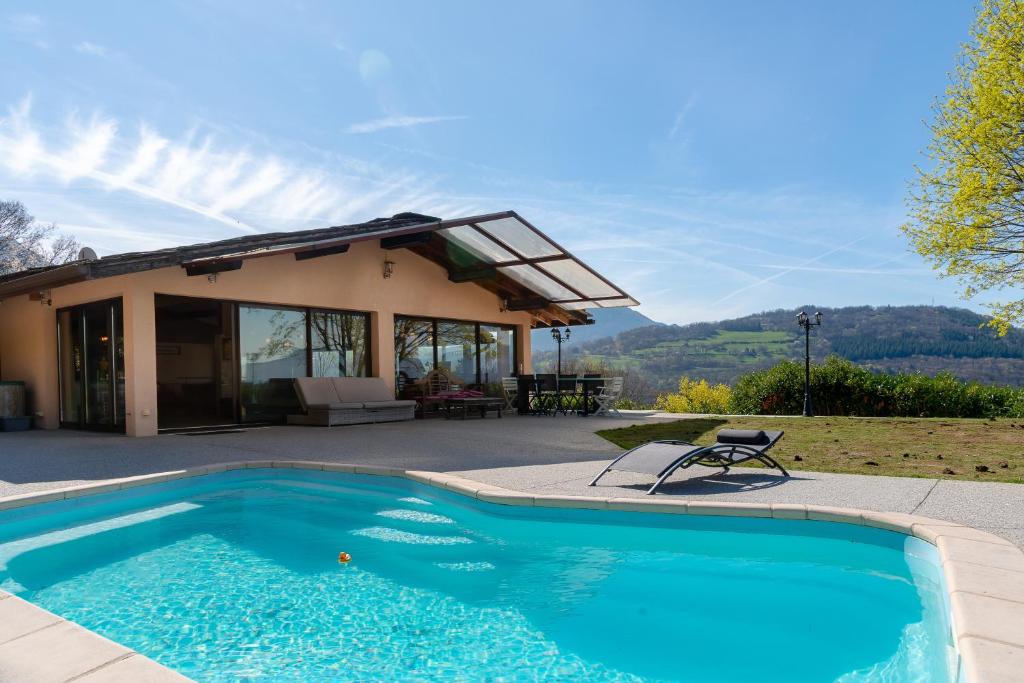 a swimming pool in front of a house at Maison avec Piscine, Spa et Jacuzzi in Saint-Jean-dʼArvey