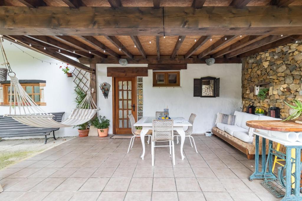 a patio with a hammock and a table and chairs at Kety in Serdió