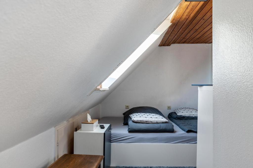 a bedroom with a bed in the attic at Storchennest in Ludwigsburg