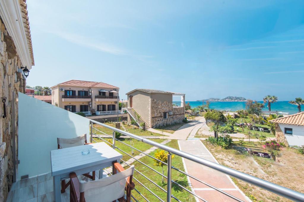 a balcony with a view of the ocean and buildings at Mirage Arillas Studio Type B14 in Arillas