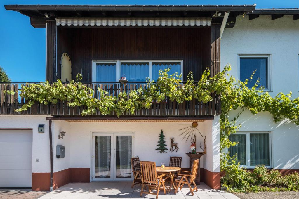 a patio in front of a house with a table and chairs at Haus Isele in Urberg