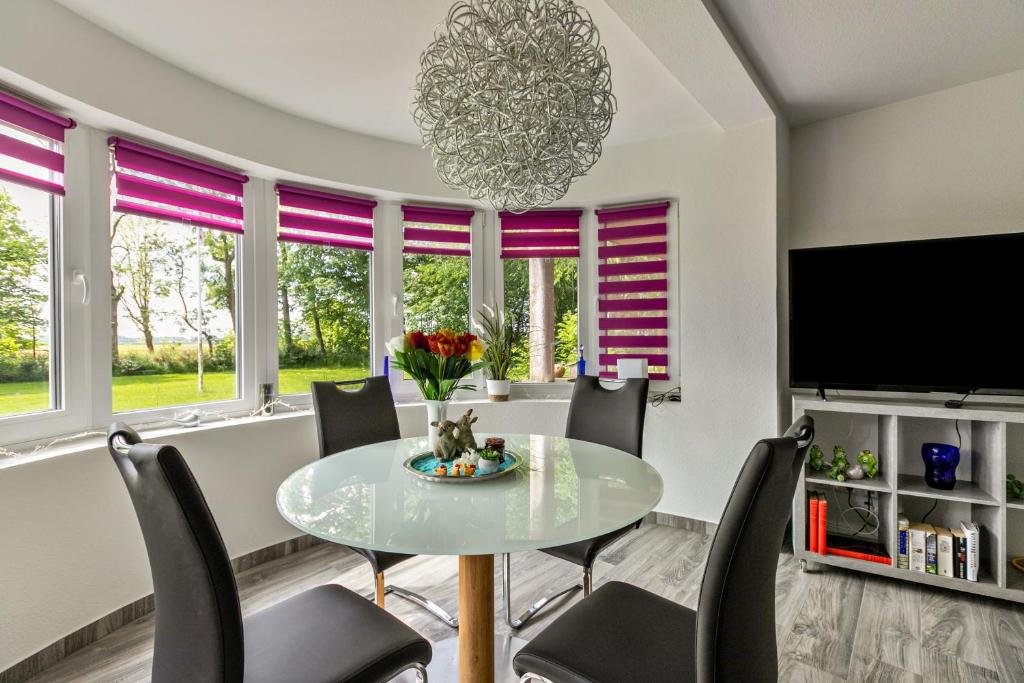 a dining room with a table and chairs at Amrum in Galmsbüll