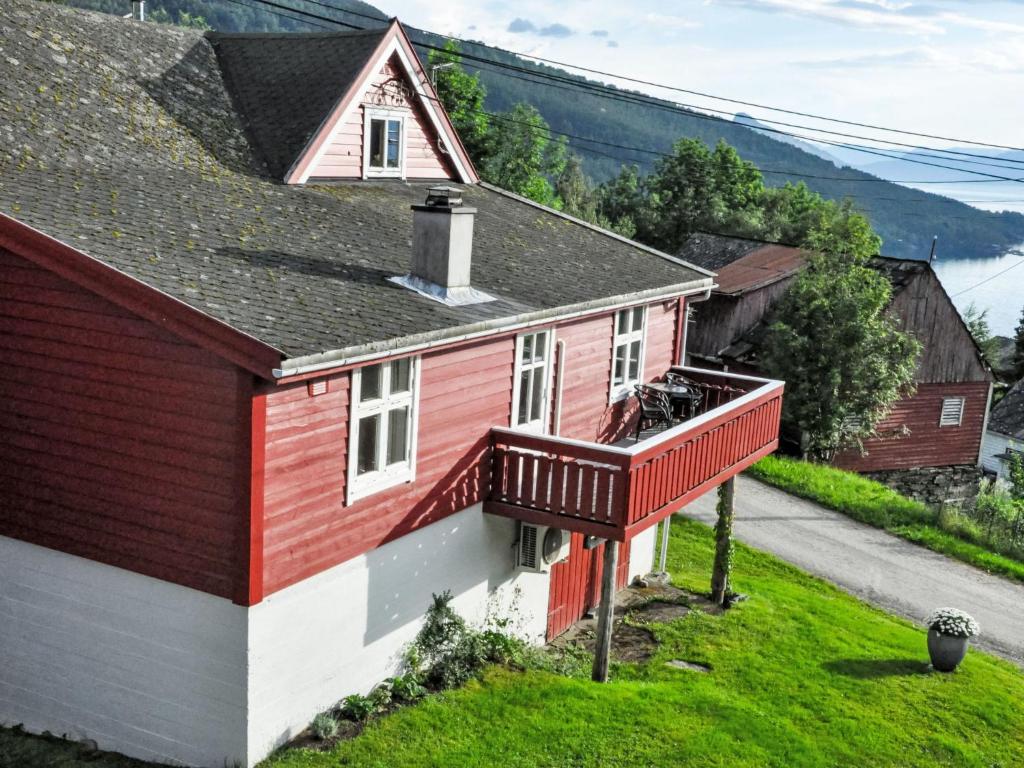 a red and white house with a balcony at Apartment Floren by Interhome in Herand