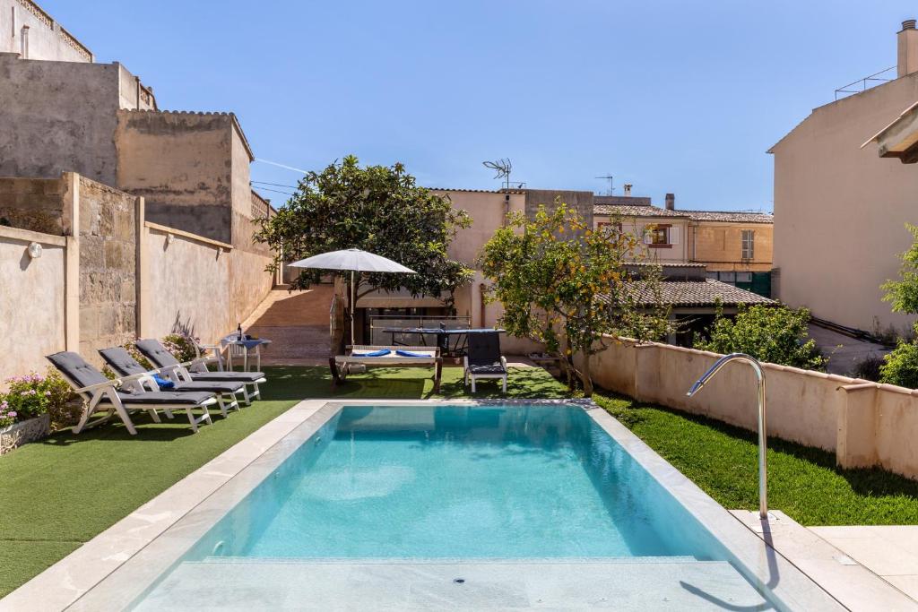 a swimming pool in the backyard of a house at Casa Magui in Capdepera
