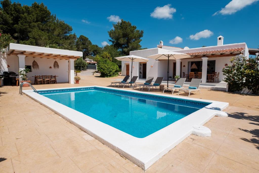 a swimming pool in front of a house at Can Joan Durban in Sant Joan de Labritja