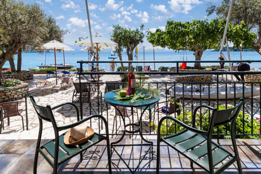 a patio with a table and chairs and the ocean at Nikiana Club - Studio 3 in Nikiana
