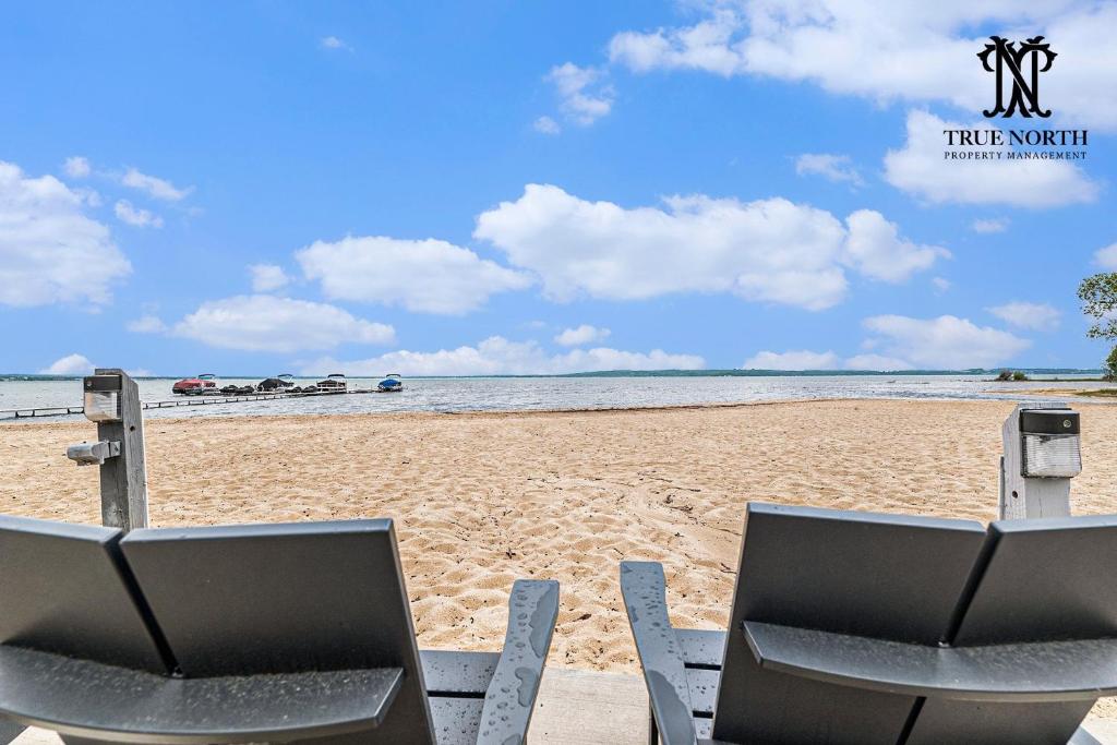 two chairs sitting on a beach with the ocean at The Shores in Williamsburg