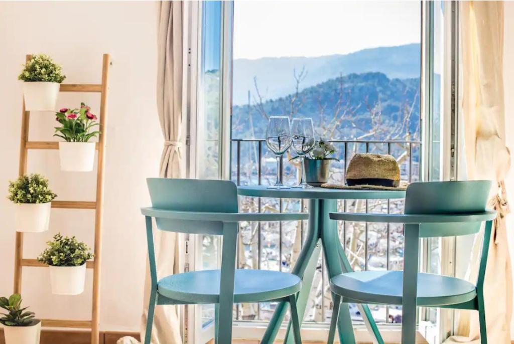 a table and two chairs in front of a balcony at Ca Na Magda in Port de Soller