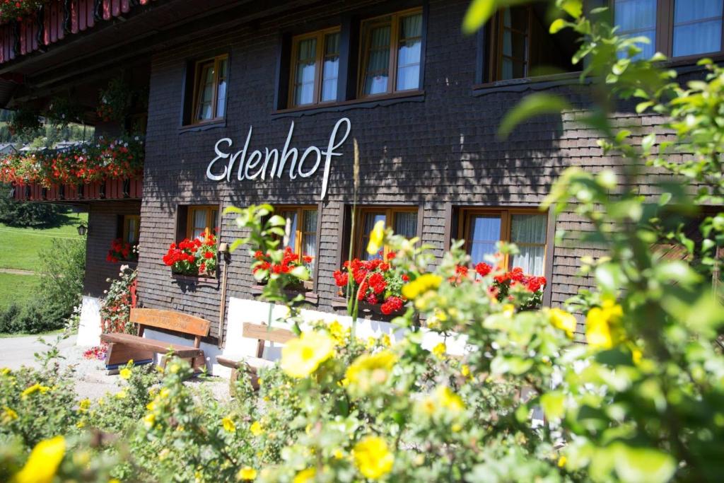 a sign on the side of a building with flowers at Erlenhof in Todtnau