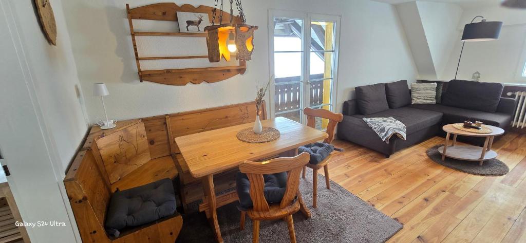 a living room with a table and a couch at Ferienwohnung Hofidylle in Münstertal