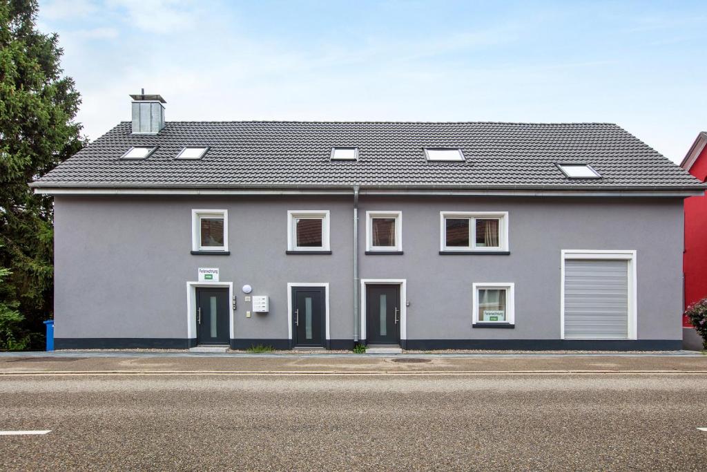 a large white house on the side of a street at Ferienapartments Ariana in Bad Säckingen