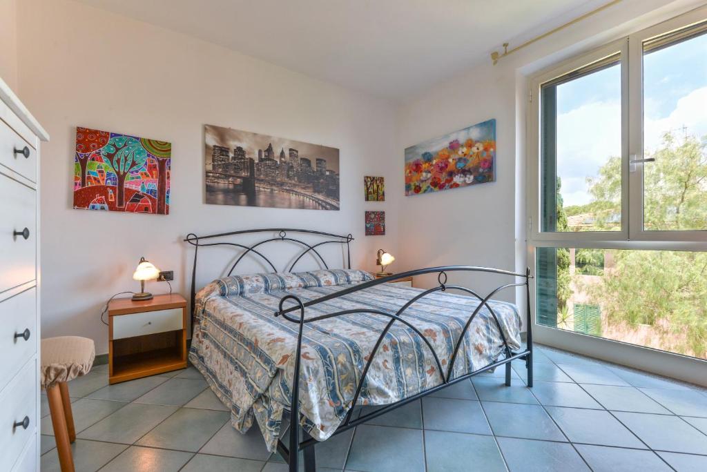 a bedroom with a bed and a window at Appartamento Trilo Fucini in Campo nell'Elba