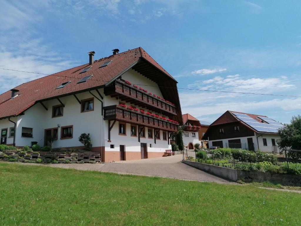 a large white building with a red roof at Stockerhof in Elzach