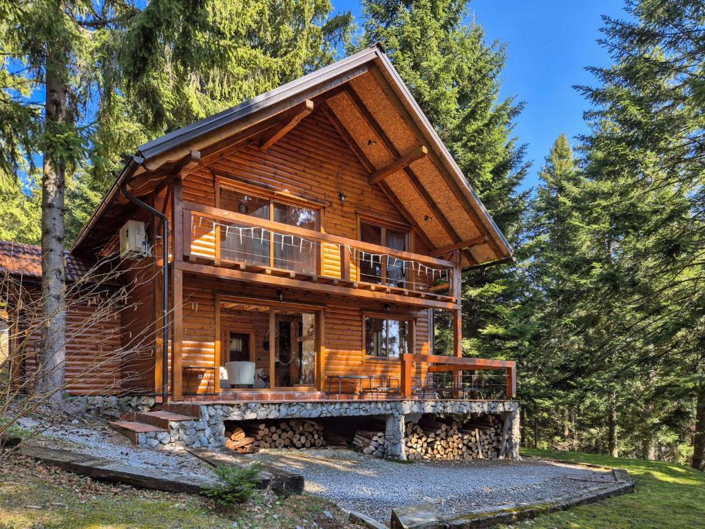 a log cabin in the woods with a wrap around porch at Chalet Hidden Heaven by Interhome in Sunger