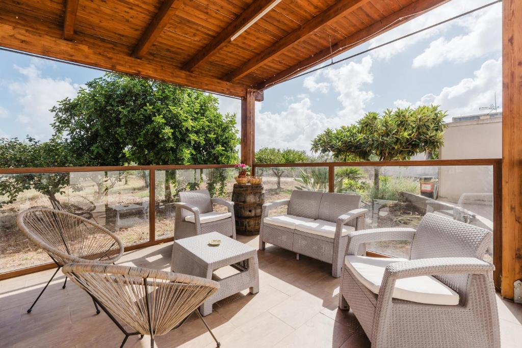 an outdoor patio with chairs and a table at Siciliantica - Rilievo in Rilievo