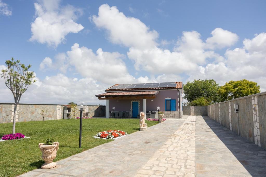 a walkway leading to a house with solar panels at La Casa Vacanza Dei Sogni in Paestum