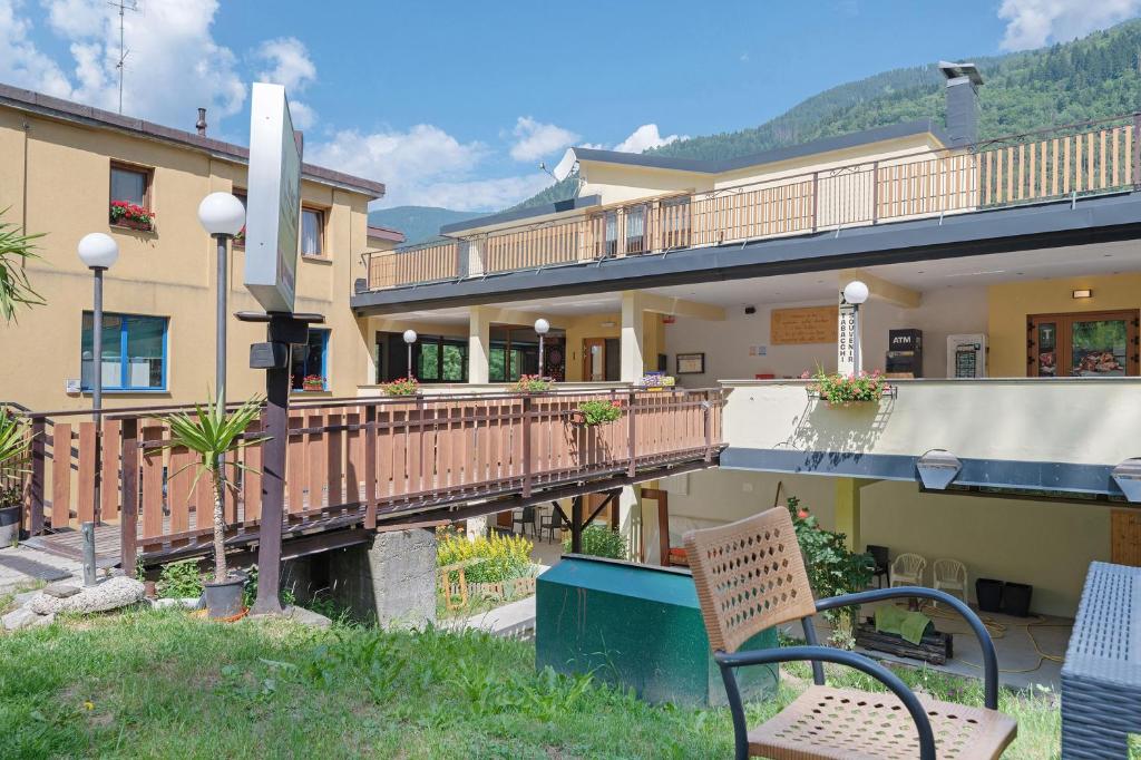 a building with two chairs and a wooden bridge at Marilleva 900 Terminal in Mezzana