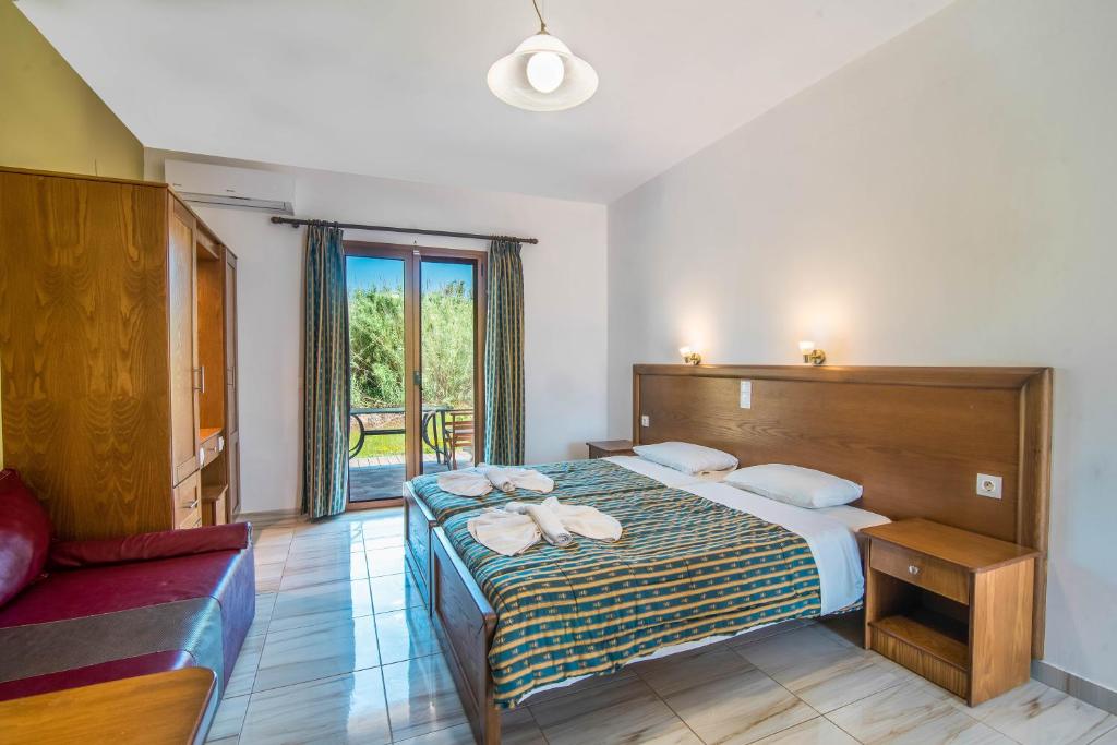 a bedroom with a bed with towels on it at Mirage Arillas Studio Type C16 in Arillas