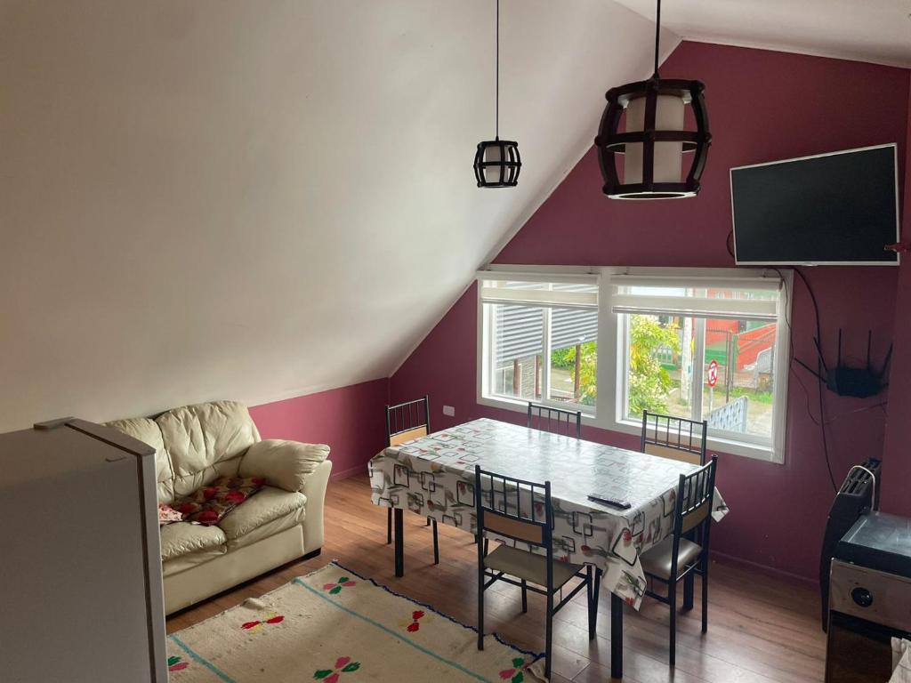 a living room with a table and a couch at Cabañas Isidora in Dalcahue
