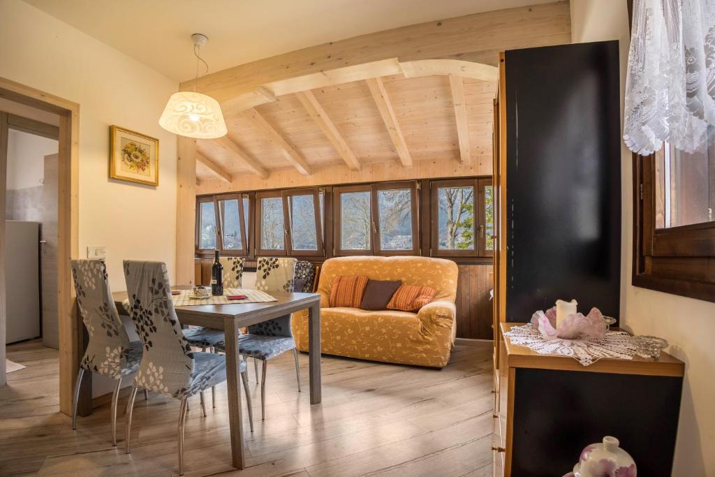 a living room with a table and a couch at Casa Camilla in Ledro