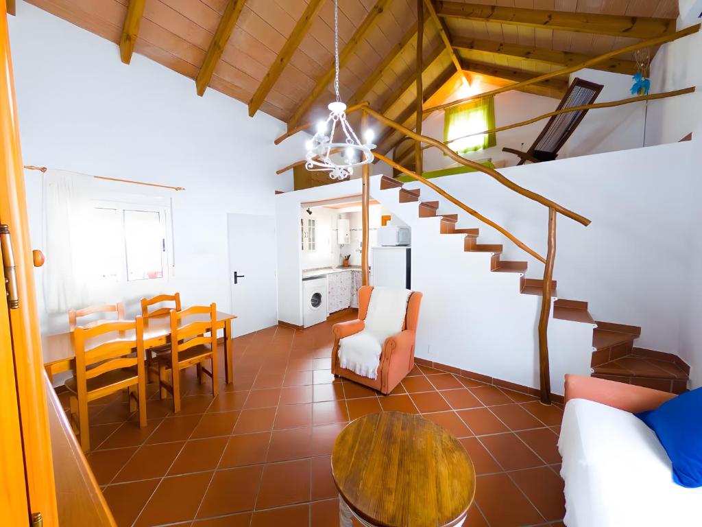 a living room with a table and a dining room at Casas Pepe 6 Bungalow in Los Caños de Meca
