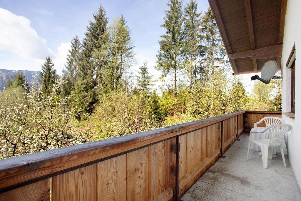 a balcony with two chairs and a view of the mountains at Wohnung Hochstaufen in Inzell