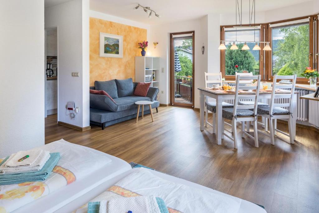 a living room with a table and a dining room at Friedolin im Bärenhüsli in Titisee-Neustadt