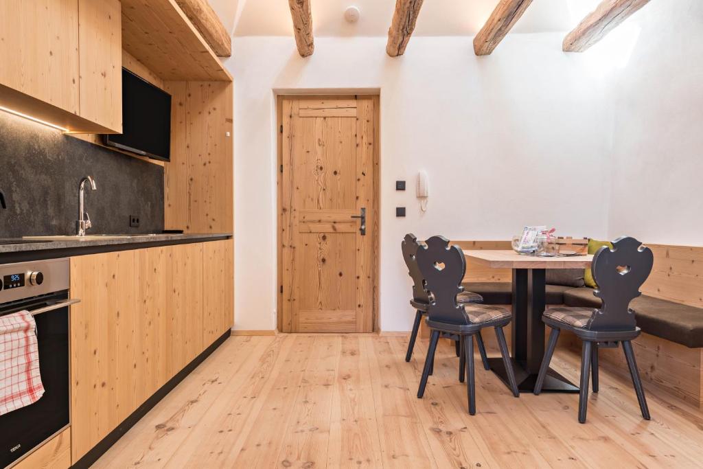 a kitchen with a table and chairs in a room at Hatzeshof Blumenwiese in Laion
