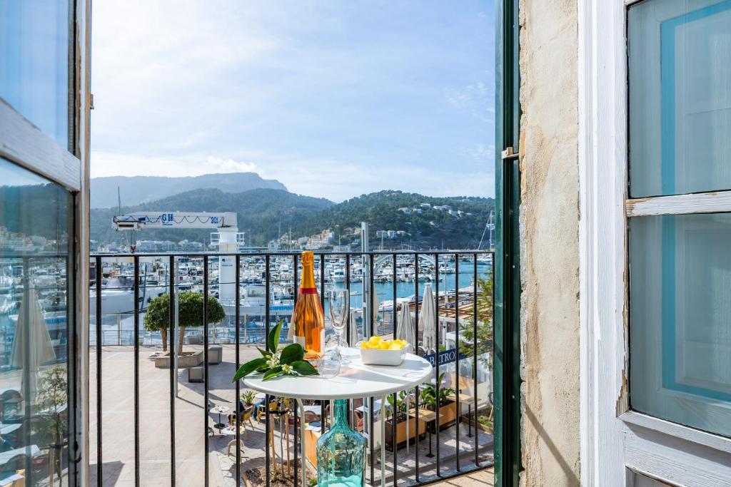 a balcony with a table and a view of the water at Marina 48 Seafront Apartment in Port de Soller
