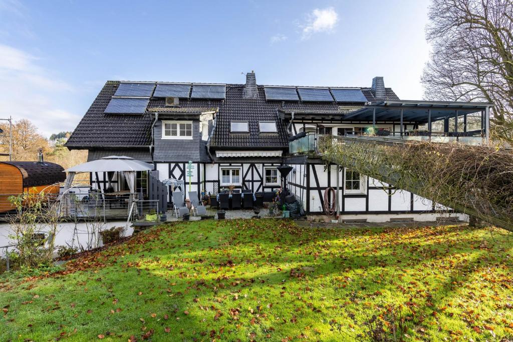 a house with solar panels on top of it at Bergisch Resort Helle in Lindlar