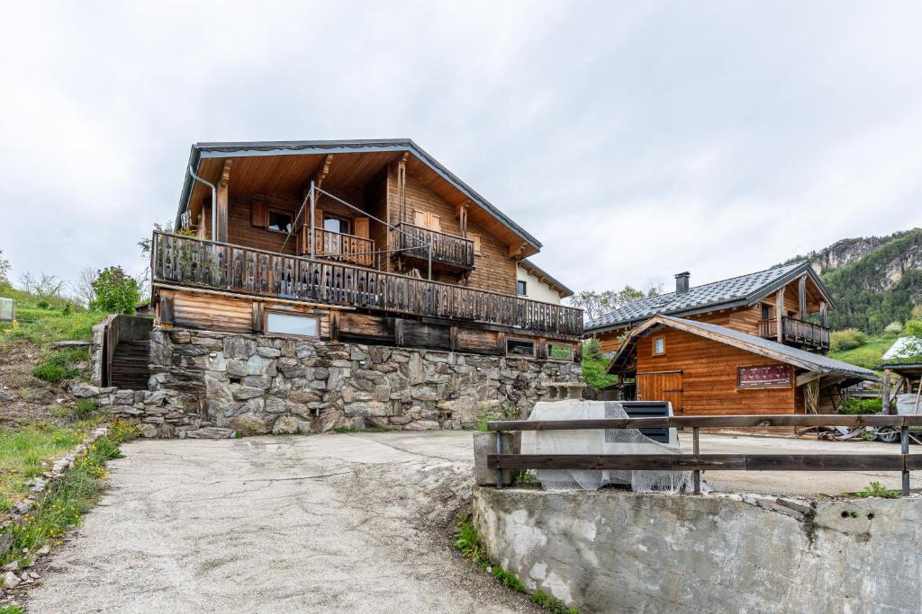 a log house with a balcony on the side of it at Chalet Les Skieurs in Notre-Dame-du-Pré