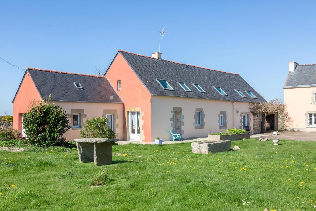 a house with a green yard in front of it at Chambres D'hôtes De Kerantum in Mahalon
