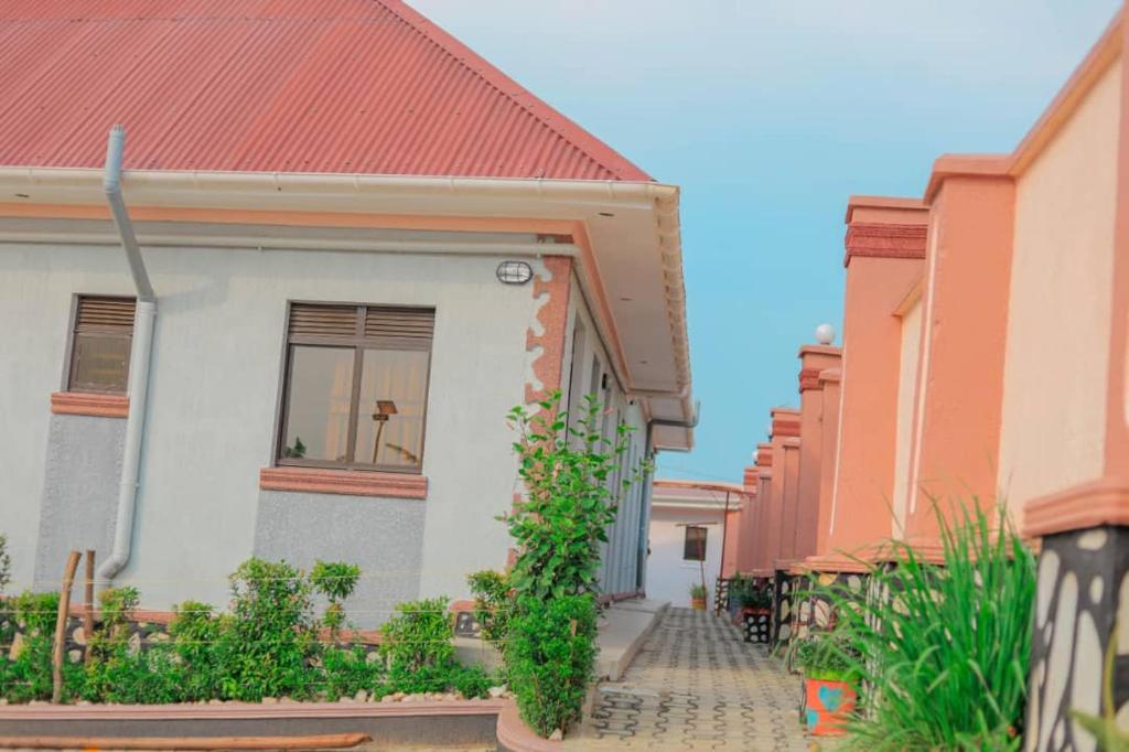 a small white house with a red roof at Innos Royale Suites in Rukungiri