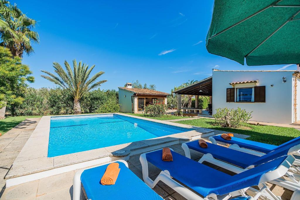a villa with a swimming pool and a house at Villa Moreno in Pollença