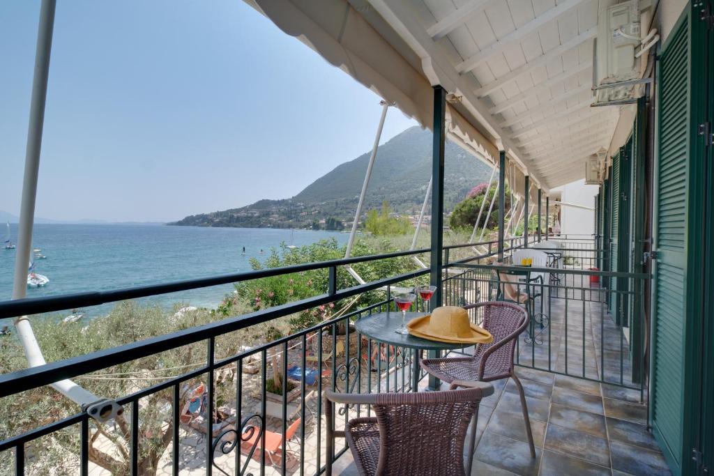 a balcony with a table and chairs and the ocean at S9 room in Nikiana