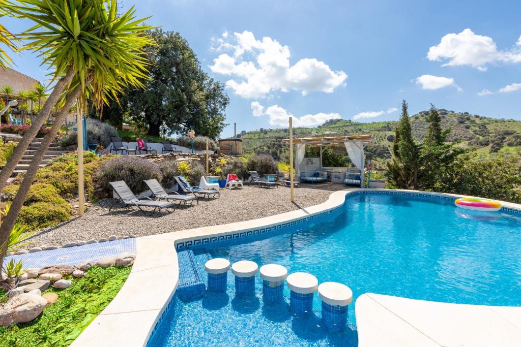 a swimming pool in the backyard of a house at Finca Las Nuevas Casa Sofia in Alora