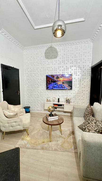a living room with a couch and a table at Nimble Focus Apartment in Lagos