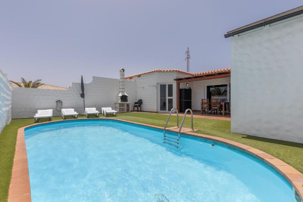 a swimming pool in the backyard of a house at Casa Betta in Costa Calma
