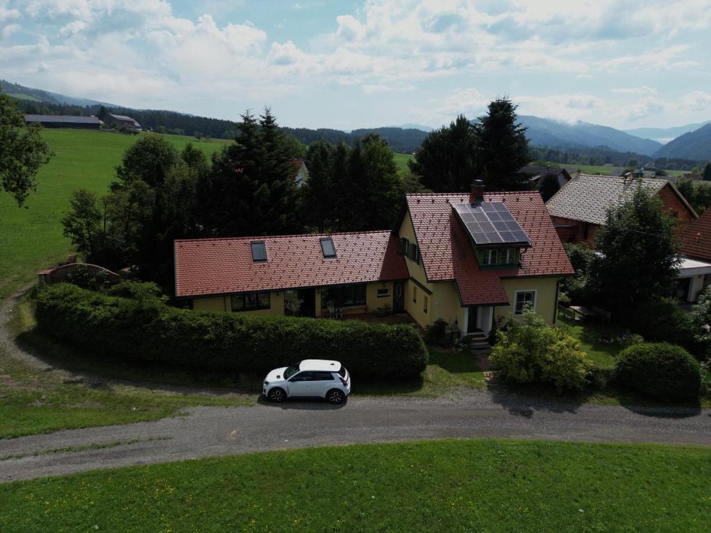a white car parked in front of a house at Ferienhaus Prettenthaler in Gaal