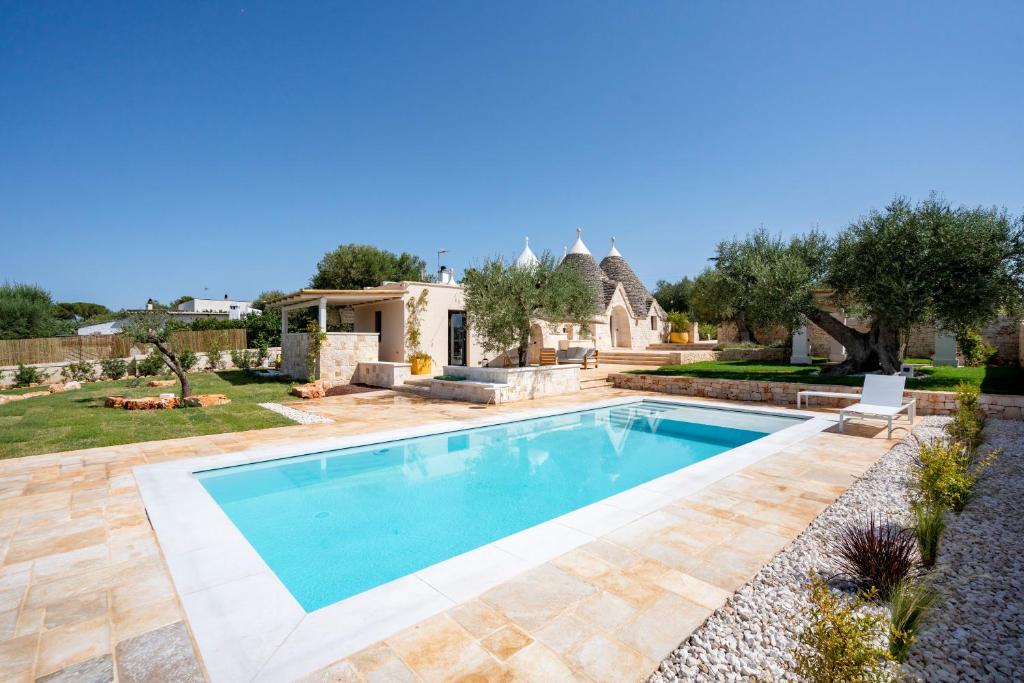 a swimming pool in a yard with a house at Dimora Dormio in Monopoli