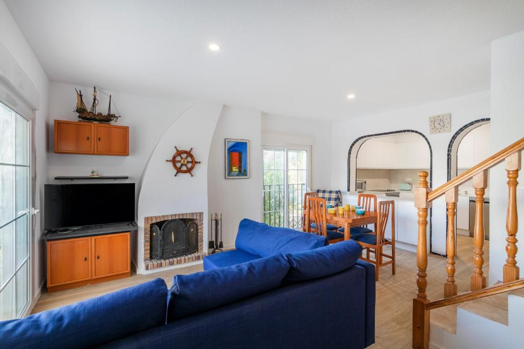 a living room with a blue couch and a table at Bungalow 213 in Alicante