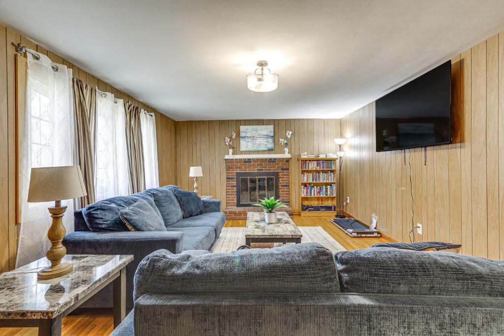 a living room with two couches and a fireplace at Walk to Shops & Eats! Attleboro Basecamp in Attleboro